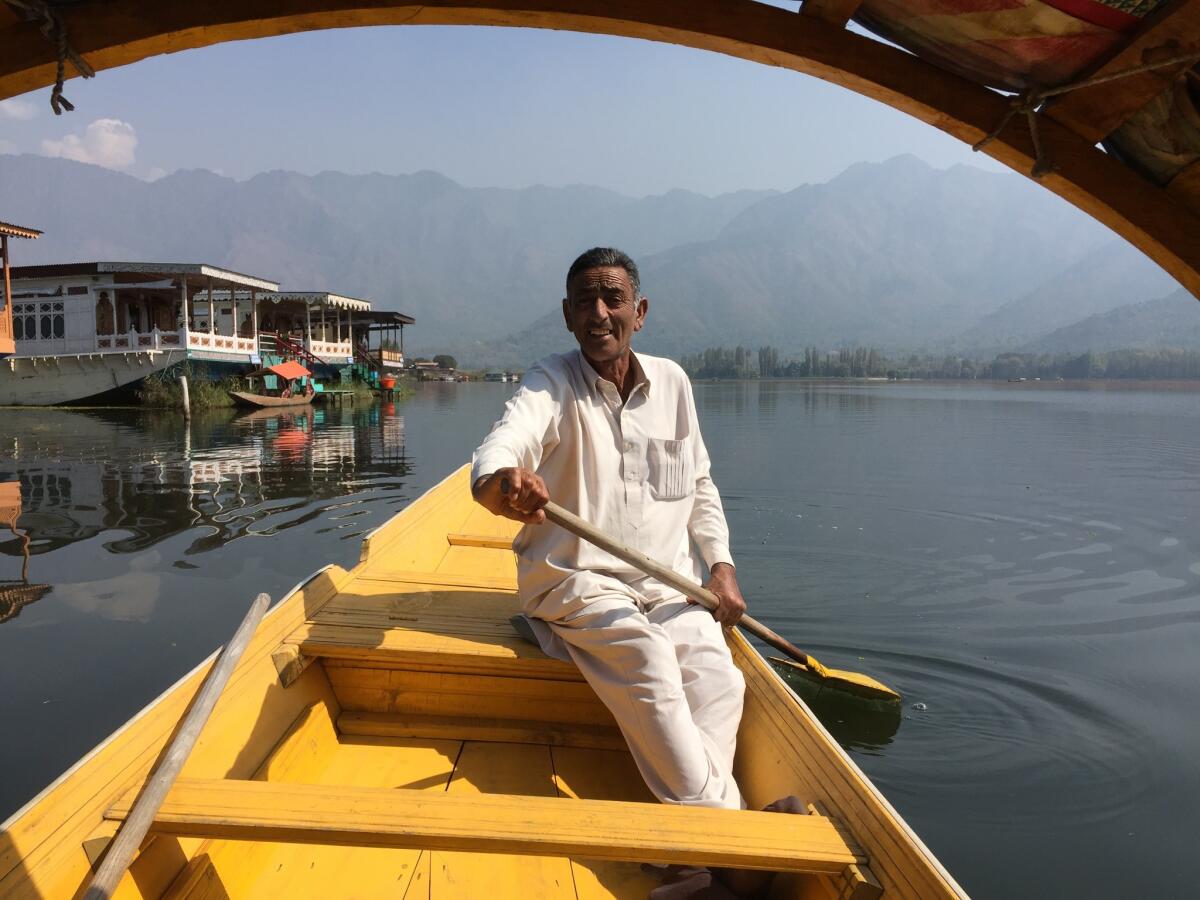 Bashir Ahmad, 62, pilots a gondola-style boat known as a shikara across Dal Lake, a tourist attraction in Indian-controlled Kashmir.