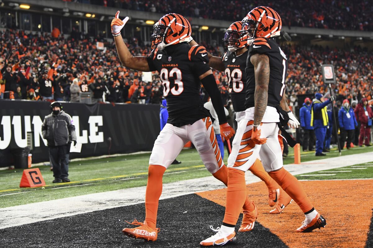 Bengals receiver Tyler Boyd (83) celebrates with teammates Joe Mixon (28) and Ja'Marr Chase after making a touchdown catch.