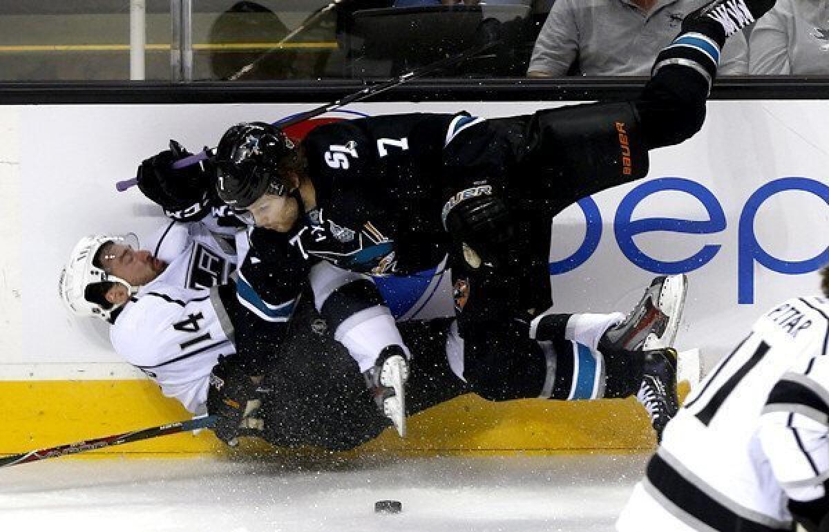 Winger Justin Williams (14) and the Kings found out in Game 3 that gaining a victory at HP Pavilion against defenseman Brad Stuart (7) and the Sharks was not easy.
