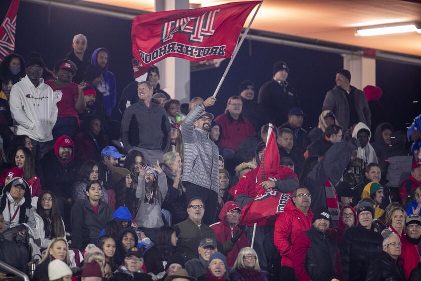 Mission Viejo, CA - December 11: Mater Dei fans cheer after a touchdown in the third quarter, as they went on to beat San Mateo Serra 44-7 to win the 2021 CIF State Football Championship Bowl Games Open Division tournament at Saddleback College, Mission Viejo, CA on Saturday, Dec. 11, 2021. (Allen J. Schaben / Los Angeles Times)