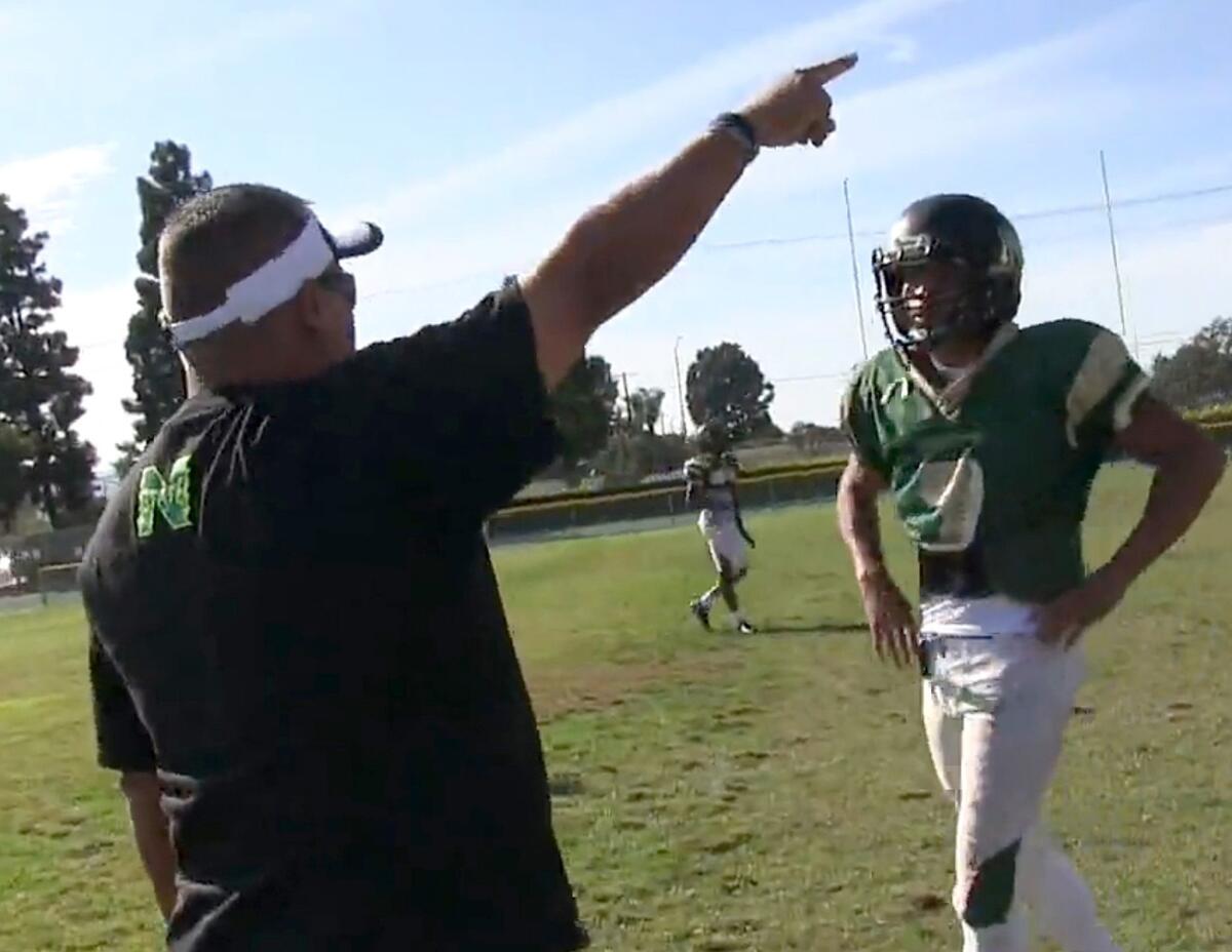 Narbonne Coach Manuel Douglas instructs quarterback Roman Ale during a fall practice.