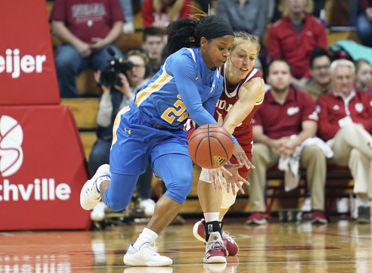 UCLA's Japreece Dean (24) steals the ball from Indiana's Ali Patberg (14) during the first half of a game Dec. 22 in Bloomington, Ind.