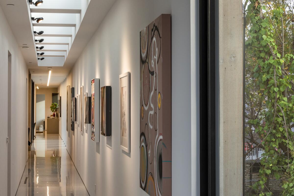 A hallway lined with paintings.