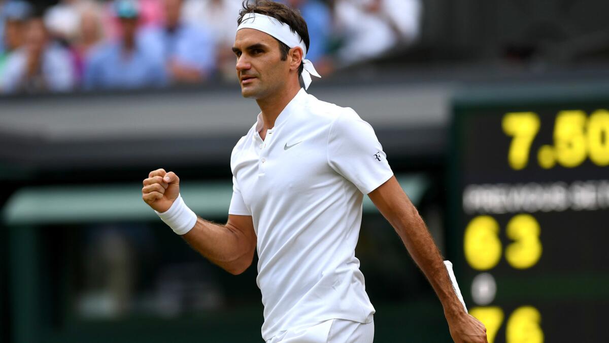 Roger Federer reacts after clinching his victory over Dusan Lajovic during a second-round match at Wimbledon on Thursday.