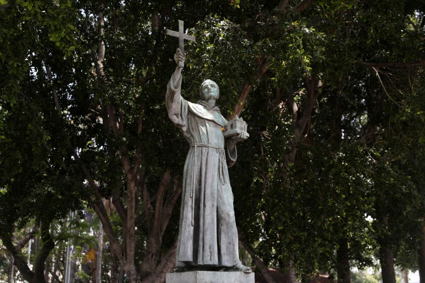 LOS ANGELES, CA - JUNE 20: Activists topple and deface with red paint the statue of Father Junipero Serra (1713 - 1784) at Father Serra Park in Pueblo Amigo on Saturday, June 20, 2020 in Los Angeles, CA. Junipero Serra, a Roman Catholic Spanish priest, who found the first nine of 21 Spanish missions in California from San Diego to San Francisco, in what was then Alta California in the Province of Las Californias, New Spain. (Gary Coronado / Los Angeles Times)