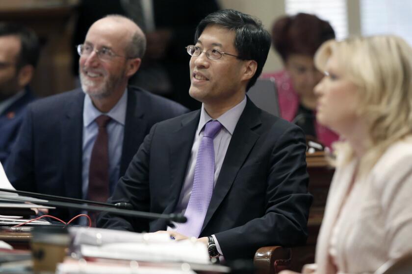 State Sen. Richard Pan, D-Sacramento, center, smiles as his measure aimed at cracking down on doctors who sell fraudulent medical exemptions for vaccinations is approved by the Senate, in Sacramento, Calif., Wednesday, Sept. 4, 2019. The bill, SB276, now goes to Gov.Gavin Newsom who said he wants last-minute changes. (AP Photo/Rich Pedroncelli)