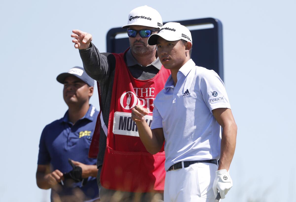 Collin Morikawa talks to his caddie on the 18th tee during the second round of the British Open.