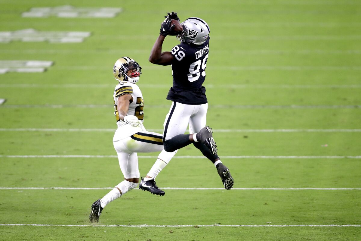 Las Vegas Raiders wide receiver Bryan Edwards (89) catches a pass over New Orleans Saints cornerback Marshon Lattimore (23) during the first half of an NFL football game, Monday, Sept. 21, 2020, in Las Vegas. (AP Photo/Isaac Brekken)