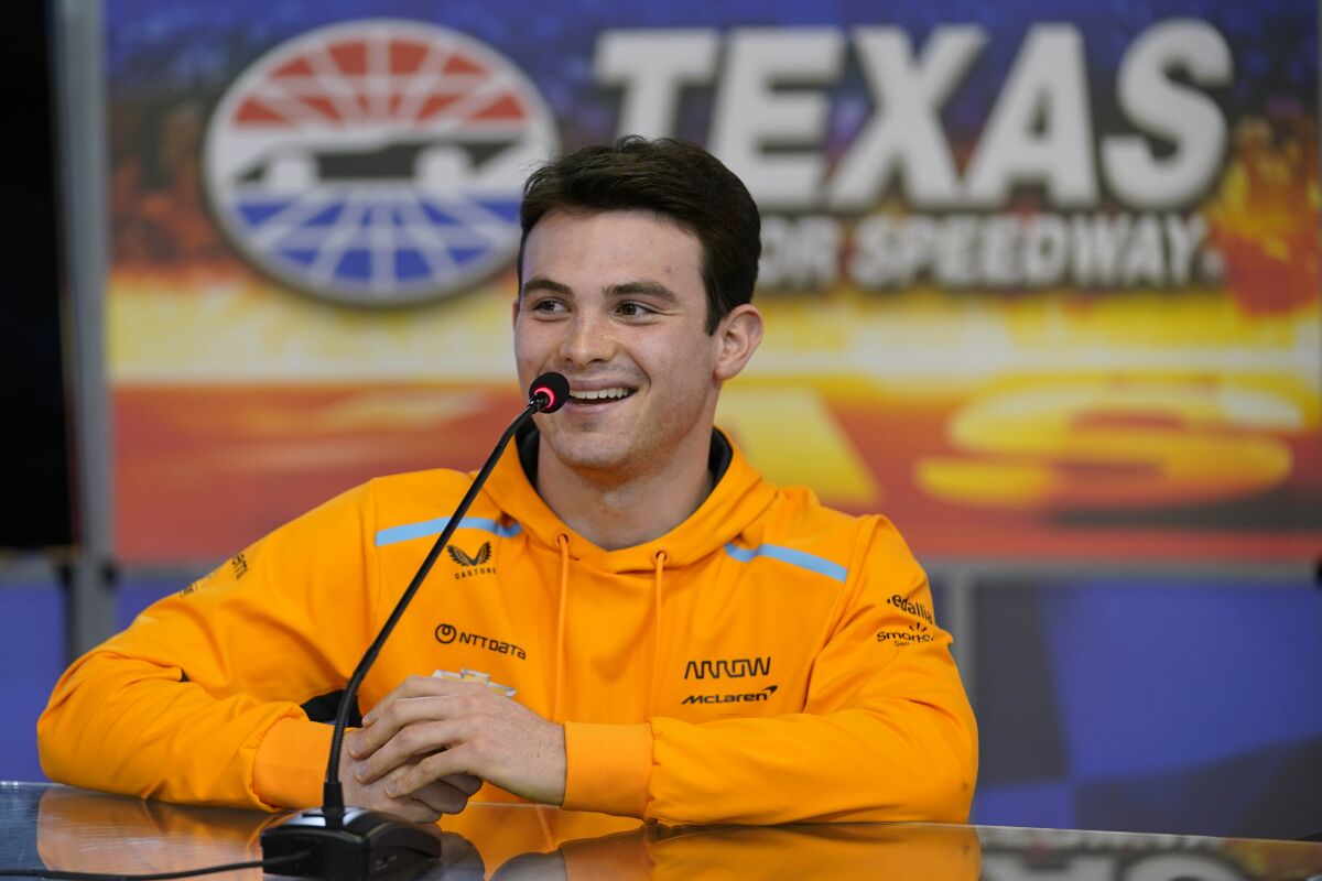 FILE - IndyCar Series driver Pato O'Ward, of Mexico, laughs as he speaks to reporters at Texas Motor Speedway in Fort Worth, Texas, Wednesday, March 15, 2023. Pato O'Ward would love to have an IndyCar race in his native country. He will be at the series' closest track this week in Texas. (AP Photo/LM Otero, File)