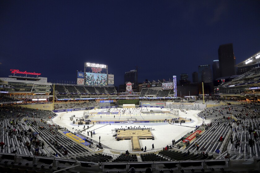 Fans in the stands wait for the Winter Classic NHL hockey game between St. Louis Blues and the Minnesota Wild on Saturday, Jan. 1, 2022, in Minneapolis. (AP Photo/Andy Clayton-King)