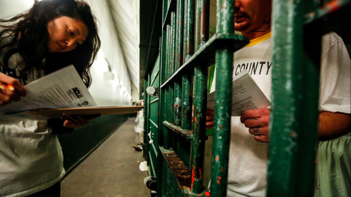 Esther Lim of the ACLU of Southern California looks over forms at Men's Central Jail as part of an initiative to educate inmates about voting rights.
