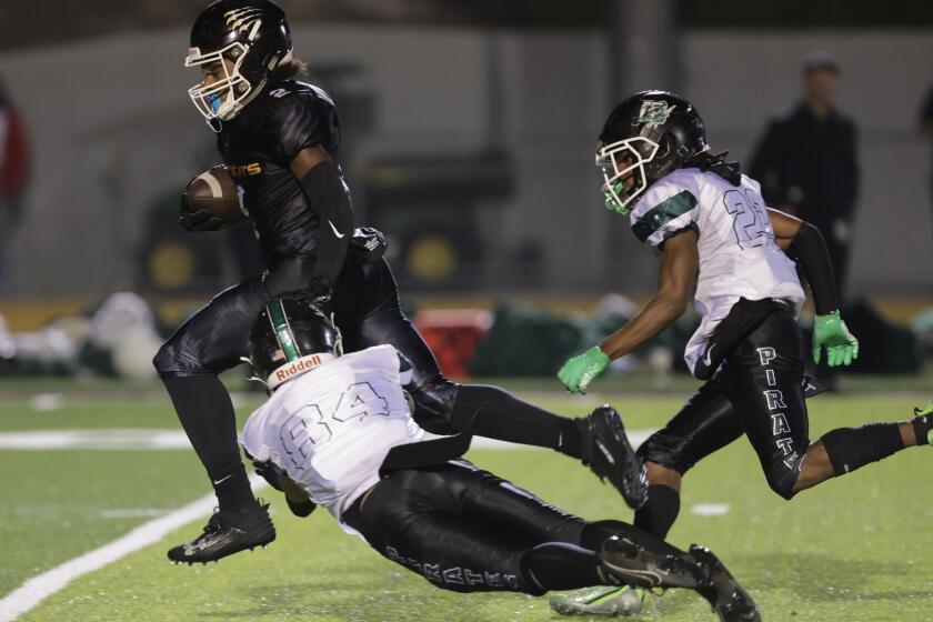 OCEANSIDE, CA - SEPTEMBER 22, 2023: Oceanside's Kymani Nua tries to stop El Camino's Caleb Reese as he runs for a touchdown during the fourth quarter at El Camino High School in Oceanside on Friday, September 22, 2023. (Hayne Palmour IV / For The San Diego Union-Tribune)
