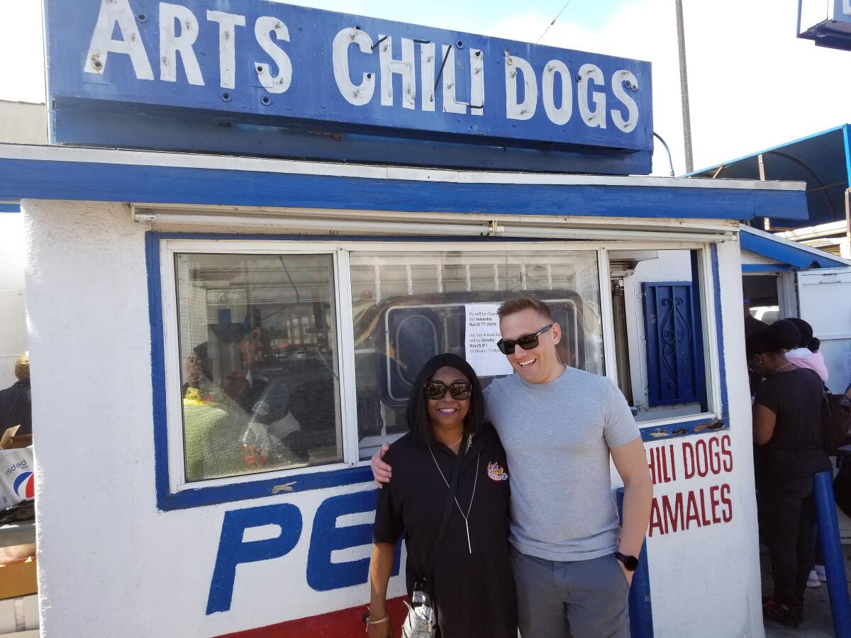 Francine Jones-Nelms, the current owner of Art's Famous Chili Dogs, with Aaron Elkind, grandson of the restaurant's original owner. 