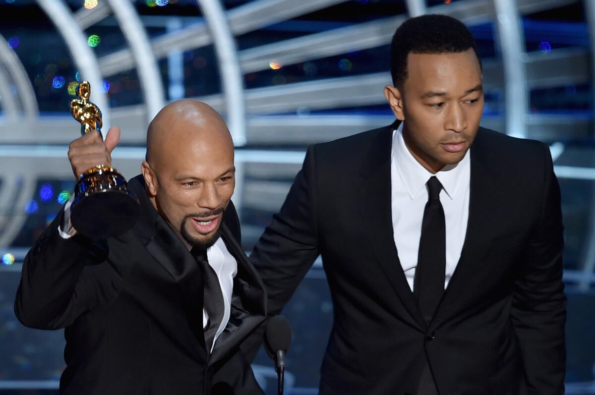 Common (left) and John Legend accept the Best Original Song Award Oscar