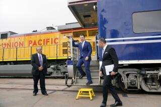 US Secretary of Transportation Pete Buttigieg, middle, steps off a railcar pulled by a PHL Joule Zero-Emission Engine to attend the groundbreaking for "America's Green Gateway," at the Pier B On-Dock Rail Support Facility in Long Beach, Calif., on Thursday, July 18, 2024. Secretary Buttigieg visited the Port of Los Angeles for the groundbreaking ceremony of a $1.5 billion rail project dubbed "America's Green Gateway" that will greatly expand service to get goods from ships across the US by train versus diesel-powered trucks that can be more polluting. (AP Photo/Damian Dovarganes)