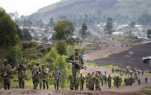 Congolese Army soldiers march north from Kibati, about six miles north of the provincial capital of Goma. Fresh fighting broke out Friday in eastern Congo, wreaking panic among civilians even as regional leaders gathered in Nairobi tried to rekindle dialogue and hammer our a road map to peace.