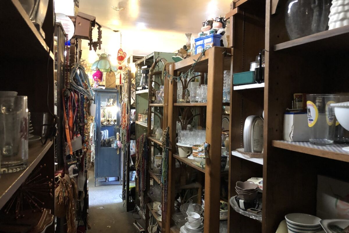 Jewelry, china and glassware on shelves at All Things and More.