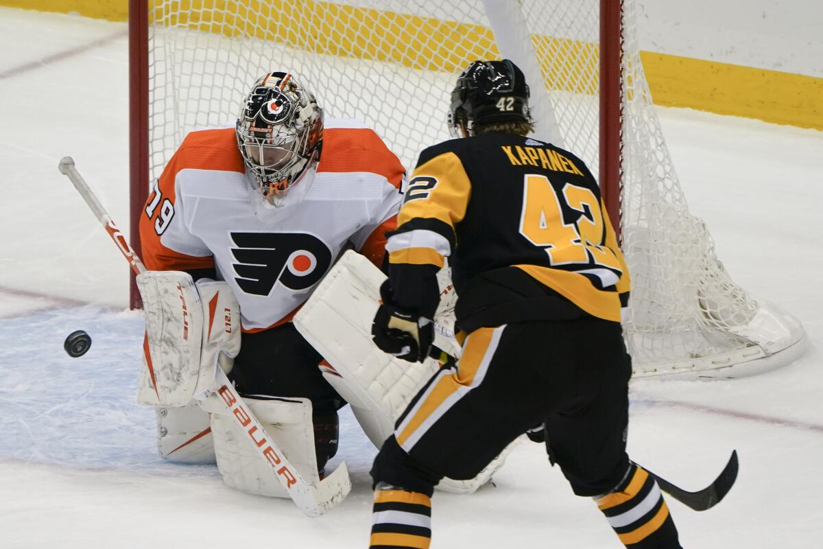 Philadelphia Flyers goaltender Carter Hart (79) stops a shot by Pittsburgh Penguins' Kasperi Kapanen (42) during the third period of an NHL hockey game Tuesday, March 2, 2021, in Pittsburgh. The Penguins won 5-2.(AP Photo/Keith Srakocic)