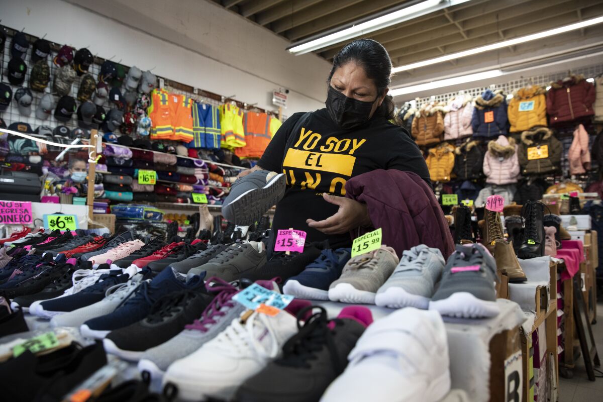 Adelina Arellano shops at Carolin Shoes in San Ysidro on Monday, the day the U.S.-Mexico border reopened.