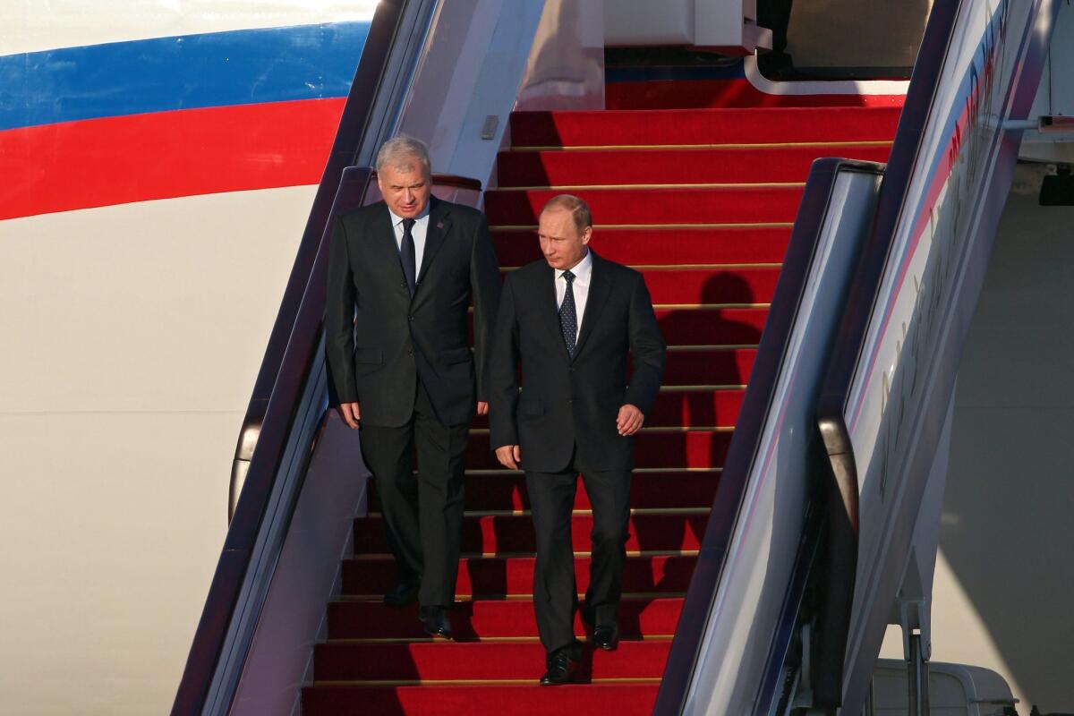 Russian President Vladimir Putin, right, arrives in Beijing on Sept. 2, 2015, to attend a military parade marking the end of World War II in Asia.