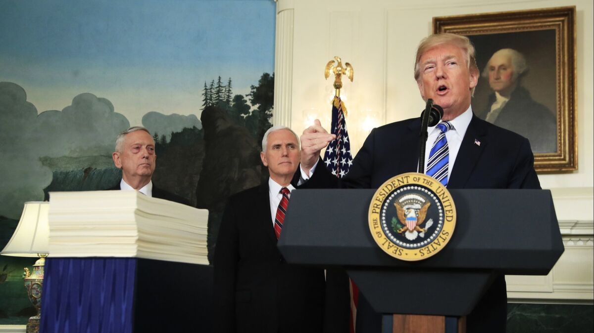 President Donald Trump with, Defense Secretary Jim Mattis, left, and Vice President Mike Pence, speaks in the White House on March 23 about the $1.3 trillion spending bil.