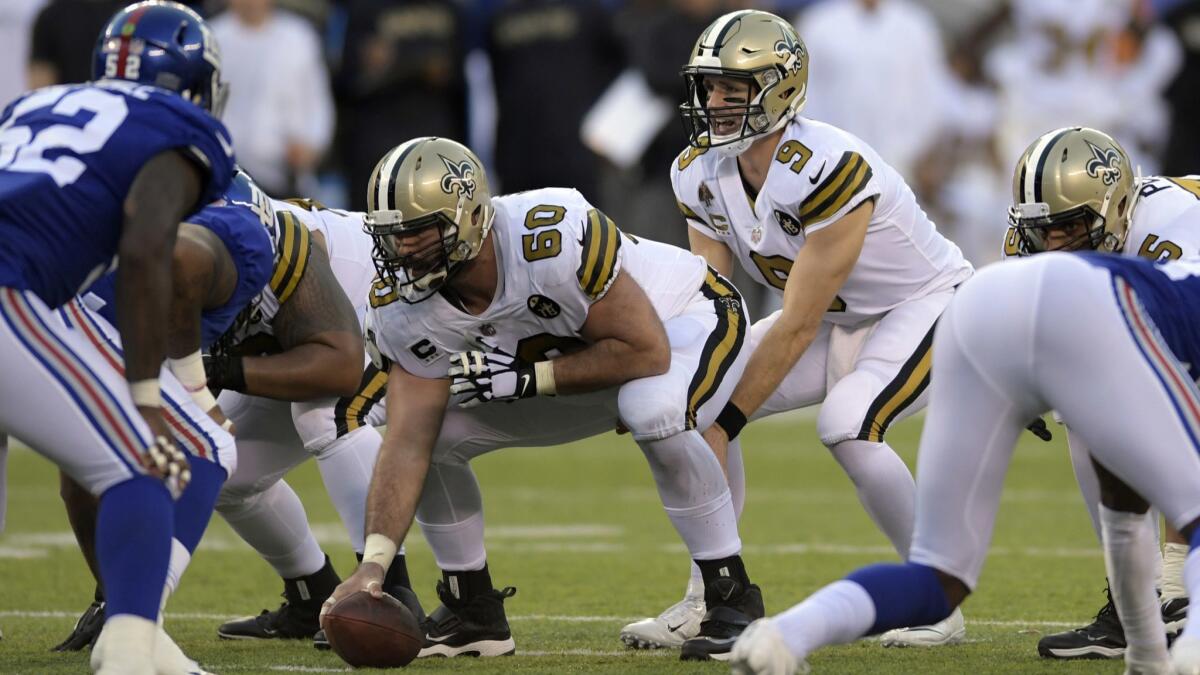 New Orleans Saints quarterback Drew Brees (9) prepares to take the snap from center Max Unger (60) during the second half against the New York Giants.