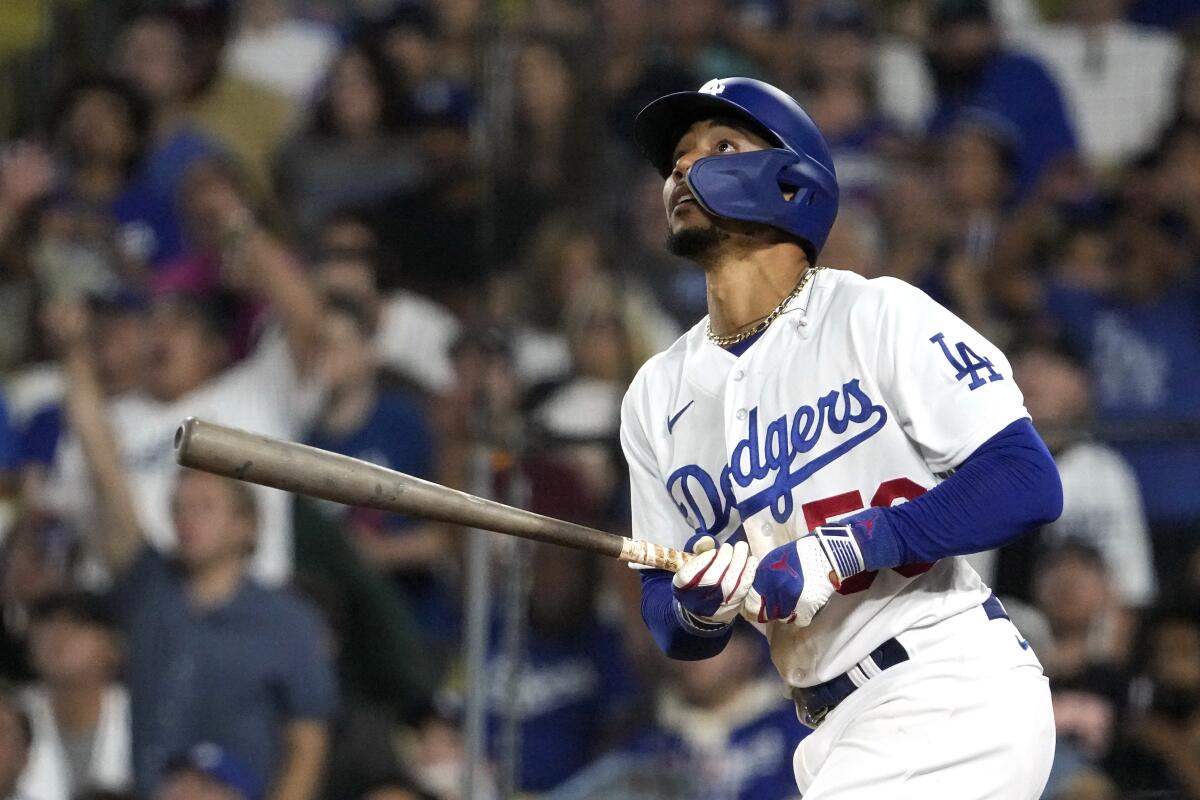 The Dodgers' Mookie Betts watches the ball go out for a solo home run.