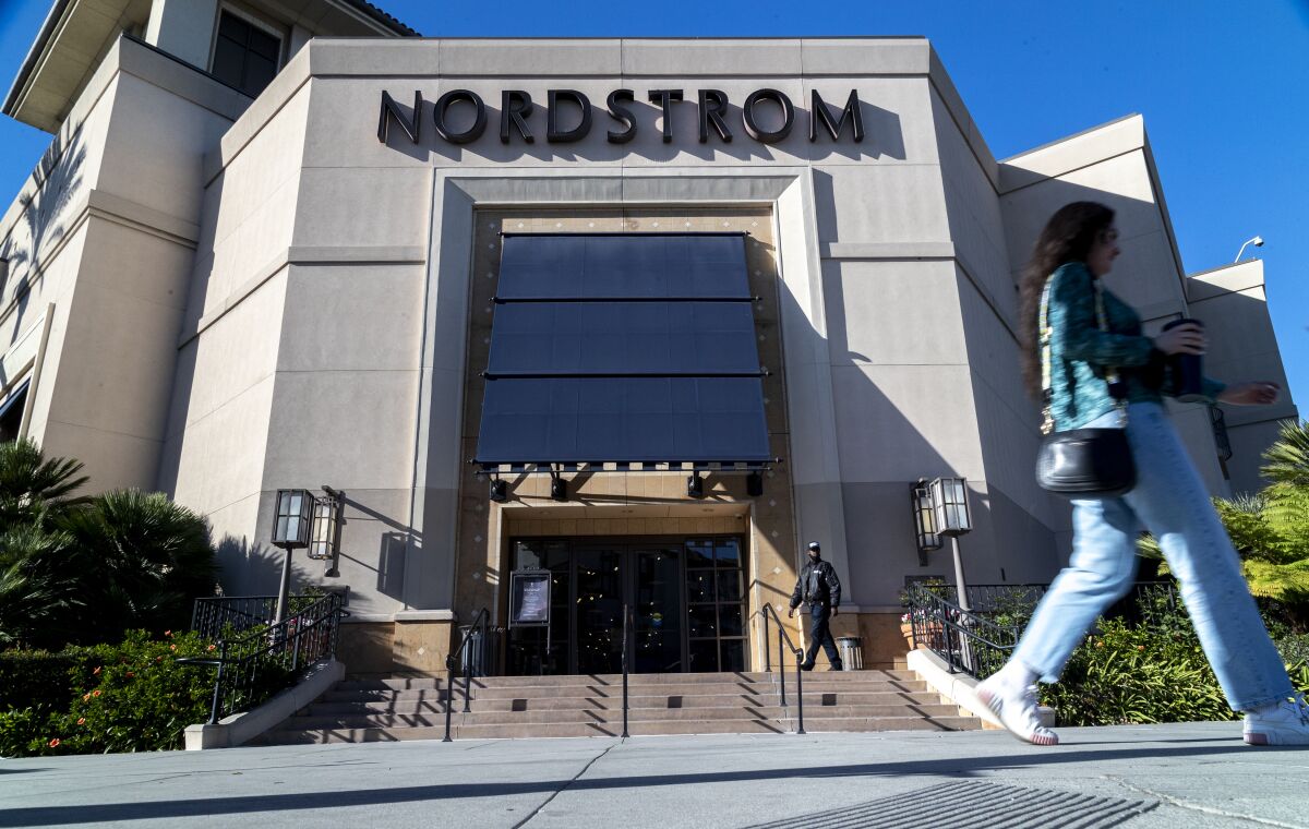 A security guard patrols the entrance of a Nordstrom store at the Grove shopping center in L.A.'s Fairfax district