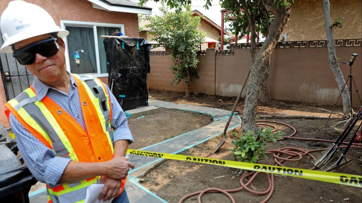 Fred Zanoria, supervisor with the field operations unit for the Department of Toxic Substances Control, in the backyard of a house being cleaned of lead-contaminated soil during an Aug. 9 bus tour of state and local government officials of the Exide residential cleanup.