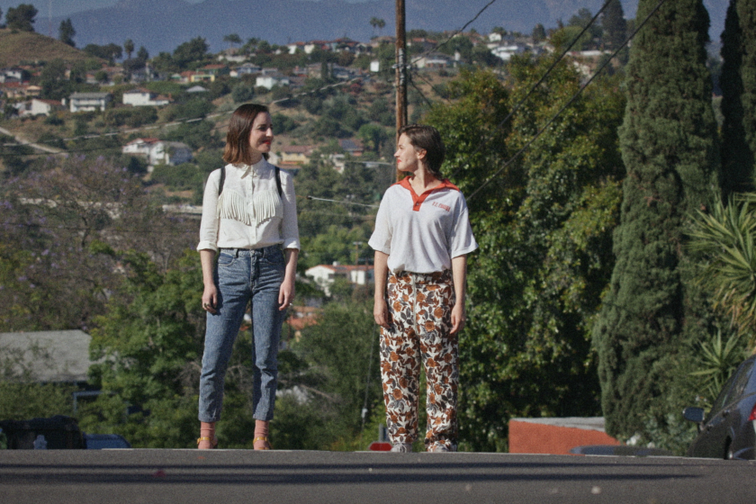 A woman (Zoe Lister-Jones) and her younger self (Cailee Spaeny) stroll around L.A. on Earth's final day in "How It Ends."