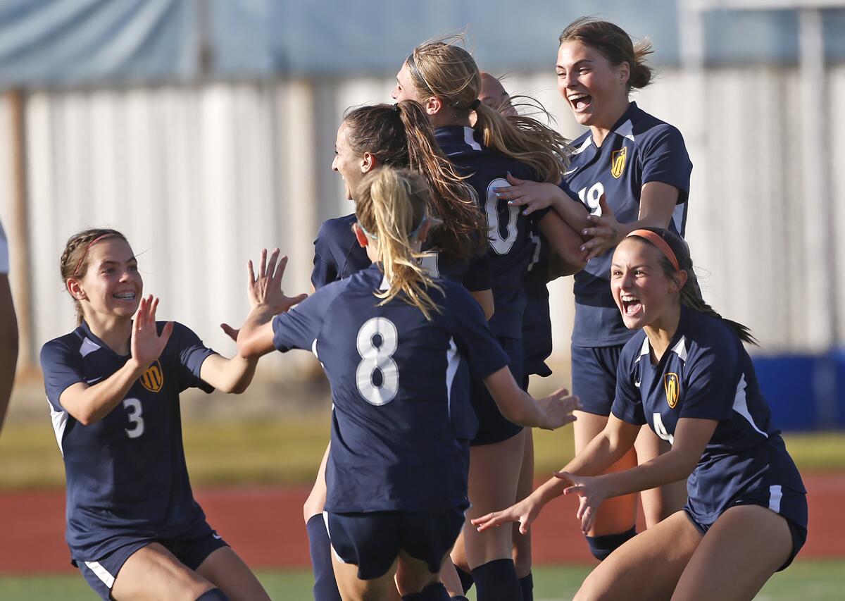 The Marina girls' soccer team celebrates a goal against Claremont Webb in a playoff game.
