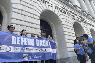 Demonstrators supporting Biden Administration efforts to protect immigrants brought to the U.S. illegally when they were children hold signs in front of the federal appeals court in New Orleans on Thursday, Oct 19, 2924. (AP Photo/Kevin McGill)