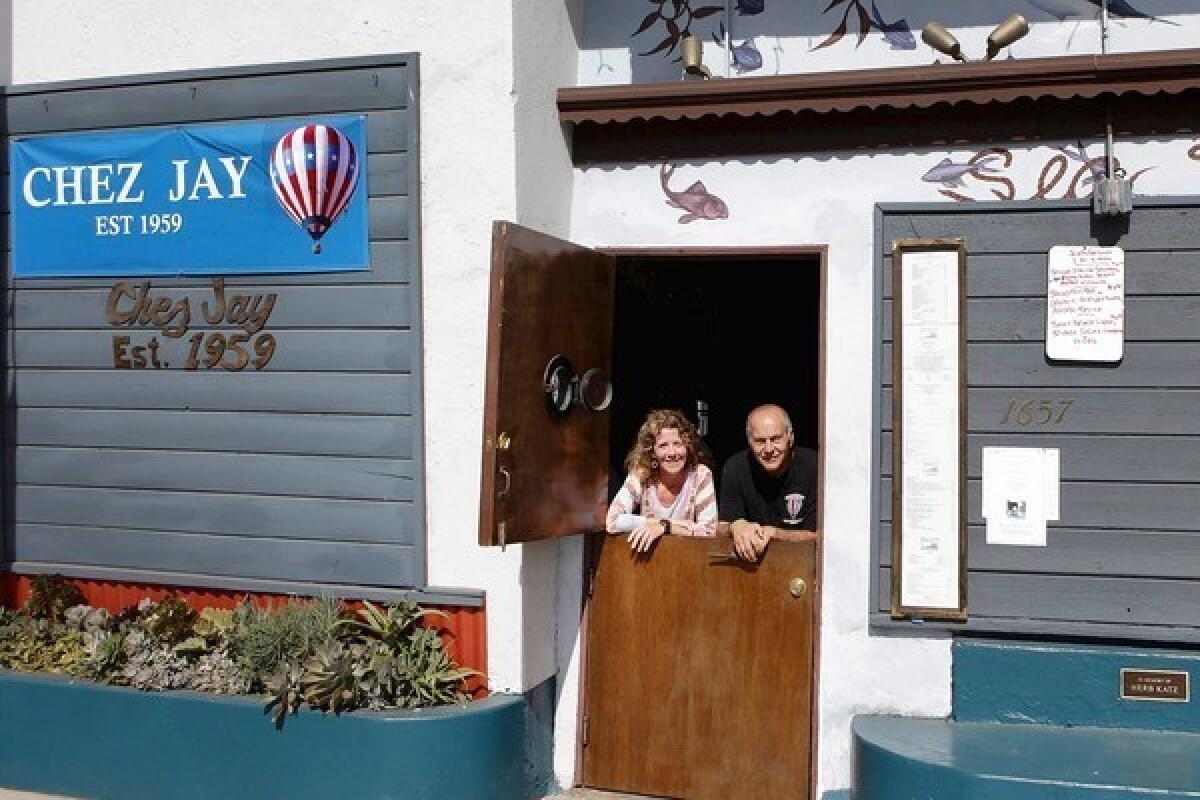 Anita Fiondella Eck, left, and Michael Anderson are two of the three owners of Chez Jay on Ocean Boulevard in Santa Monica. The third, not shown, is Chaz Fiondella.