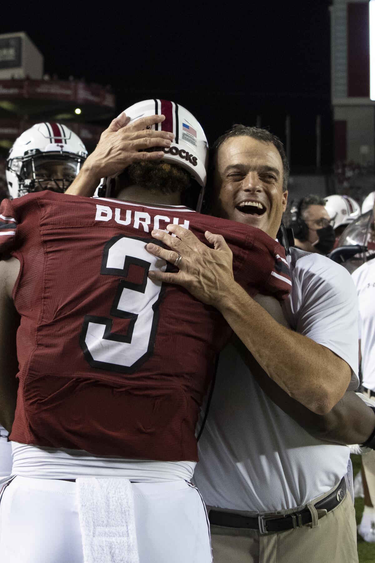 South Carolina defensive end Jordan Burch (3) celebrates with head coach Shane Beamer after his pick six during the second half of an NCAA college football game against Eastern Illinois, Saturday, Sept. 4, 2021, in Columbia, S.C. (AP Photo/Hakim Wright Sr.)