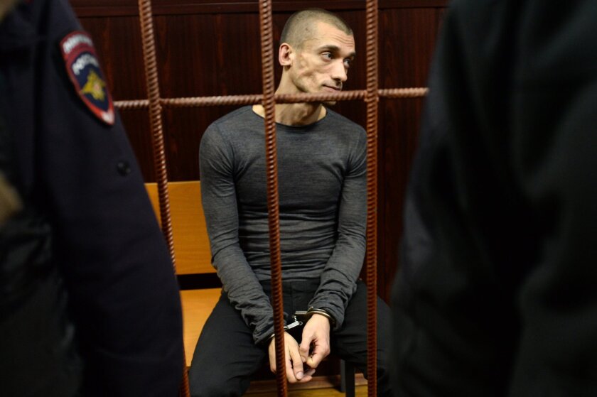Russian performance artist Pyotr Pavlensky sits in a courtroom before a hearing on his case in Moscow on Nov. 10, 2015.