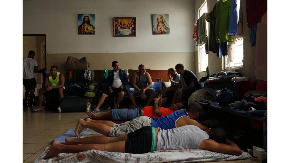 Migrants from Cuba, Haiti, Nepal and African nations rest in a shelter in Panama City in September 2016.