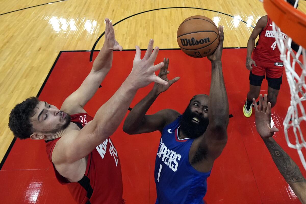 The Clippers' James Harden goes up for a shot in the paint under pressure from the Rockets' Alperen Sengun Wednesday 