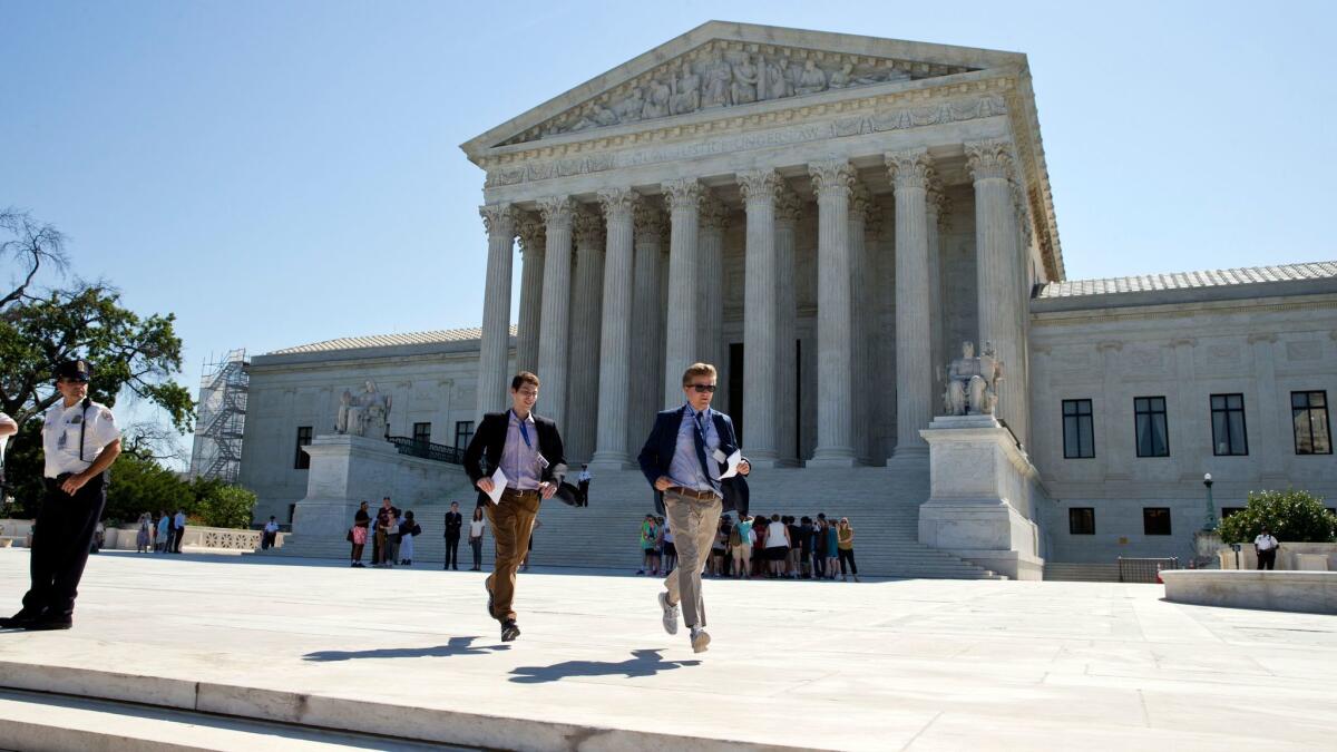 Runners leave the Supreme Court in Washington with papers announcing court decisions on June 20. The high court has been down one justice and ideologically deadlocked on a range of issues since Justice Antonin Scalia's death in February.
