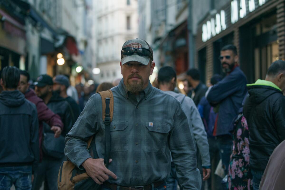 Matt Damon walks down a city sidewalk in the movie "Stillwater."