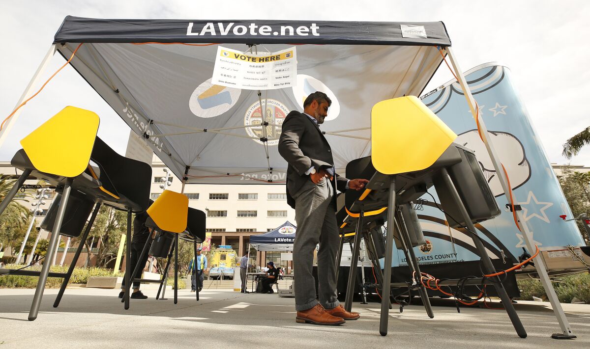 A man casting a ballot at a polling station.