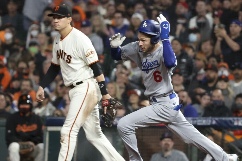San Francisco, CA - October 09: Los Angeles Dodgers' Trea Turner, right, rounds first on a double.