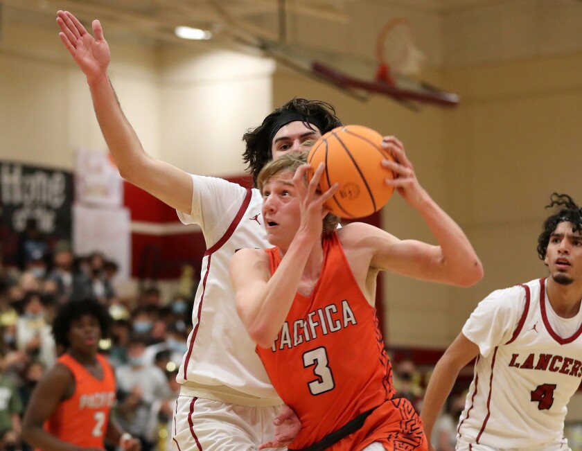 Parker Strauss (3) of Pacifica Christian drives to the basket for a lay-up during a CIF playoffs opener at Whittier La Serna.