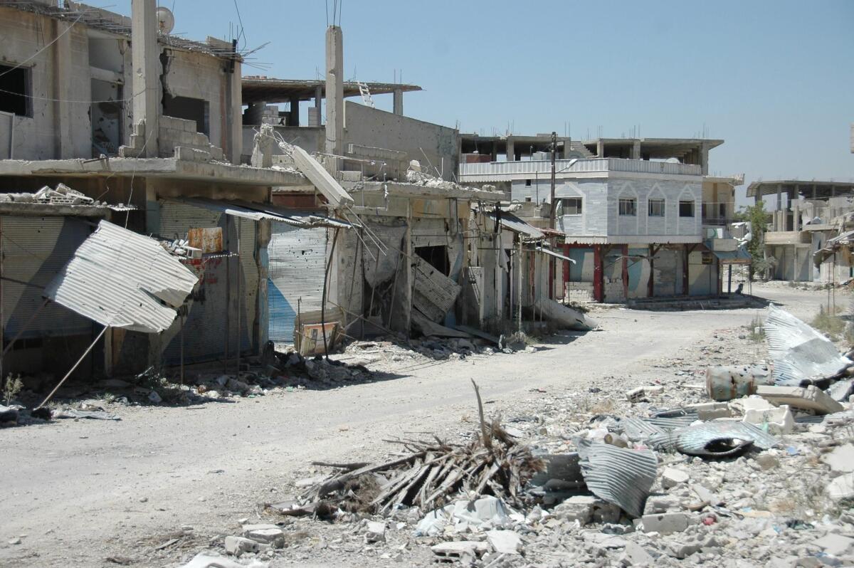 Damaged buildings in Qusair city, Homs province in central Syria on Thursday, after Syrian soldiers, backed by Hezbollah fighters, seized total control of the city and the surrounding regions.