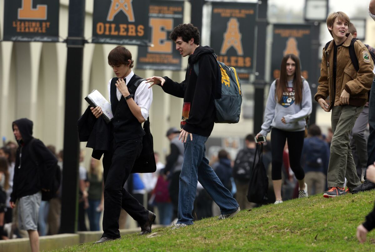 Students go about their business at Huntington Beach High School after being warned that one person on campus was diagnosed with measles in January.