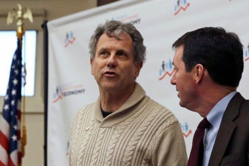 U.S. Sen. Sherrod Brown, D-Ohio, left, speaks with N.H. Rep. Tom Sherman, D-Rye, prior to an economic roundtable discussion at Winnacunnet High School in Hampton, N.H., Friday, Feb. 8, 2019. Sen. Brown is weighing a run for in 2020 presidential race. (AP Photo/Charles Krupa)