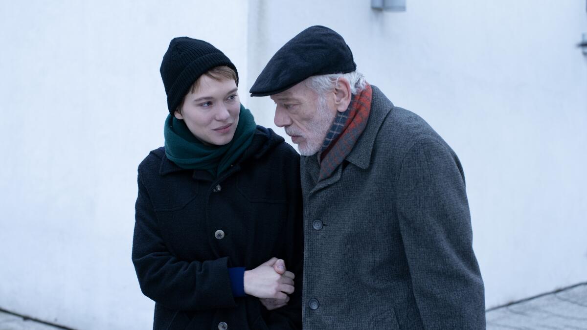 A young women in hat and coat walks with an aging man also dressed warmly in "One Fine Morning."