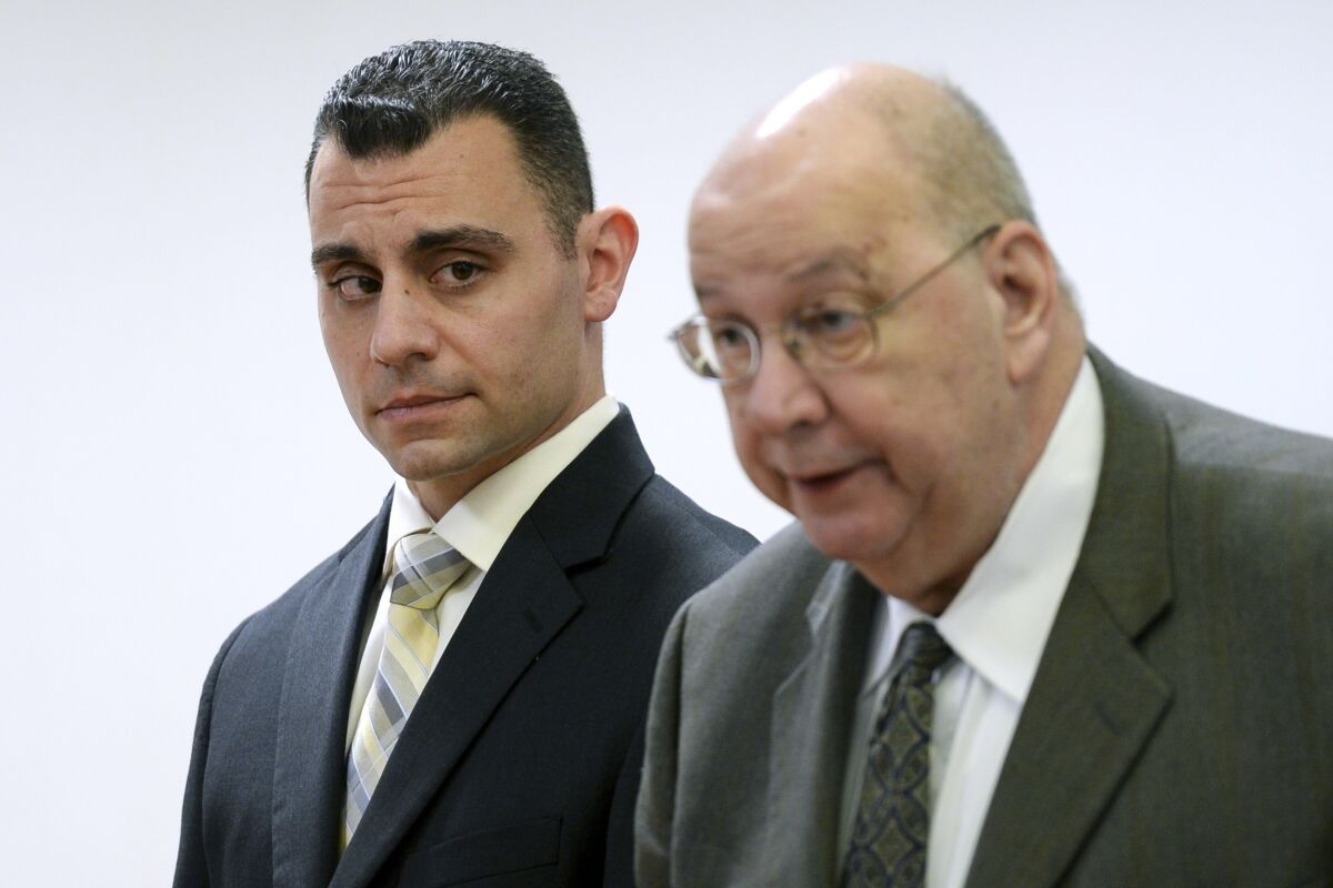 FILE - In this April 28, 2017, file photo, Richard Dabate, left, stands with his lawyer Hubert Santos at Superior Court in Rockville, Conn. Dabate has been convicted of murder in the 2015 killing of his wife in a case built partly on evidence provided by her Fitbit exercise activity tracker. A jury in Rockville Superior Court found Richard Dabate guilty Tuesday, May 10, 2022 after a five-week trial. (Stephen Dunn/Hartford Courant via AP, Pool, File)