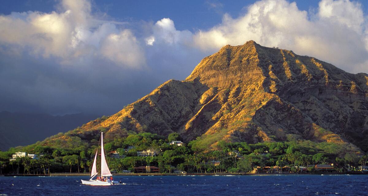 A sailboat heads to the wind with iconic Diamond Head, almost synonymous with Honolulu, as a backdrop. Travelzoo voted Honolulu as the friendliest U.S. City.