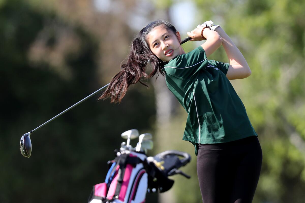 Costa Mesa's Sydney Ngo tees off on Hole No. 4 against Estancia during the Battle for the Bell golf match on Wednesday.