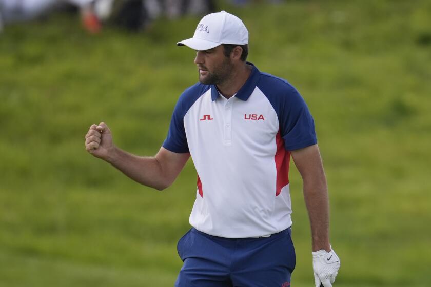 Scottie Scheffler, of the United States, reacts after making a birdie on the 2nd green.